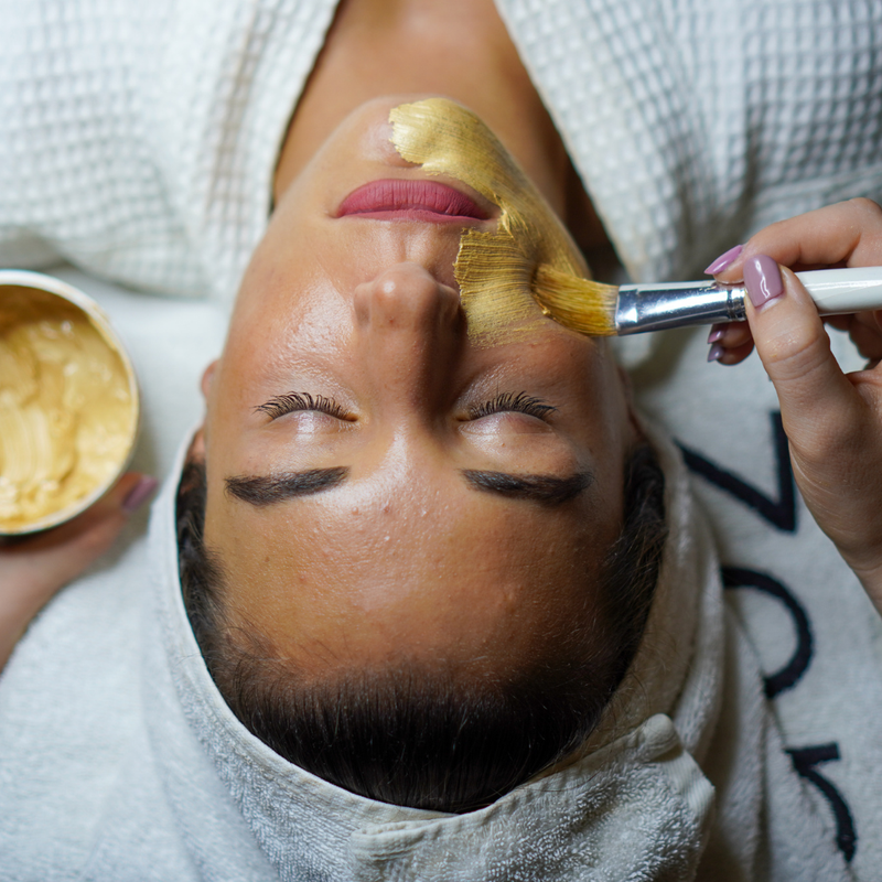 Applying a turmeric-infused mask for brightening skin