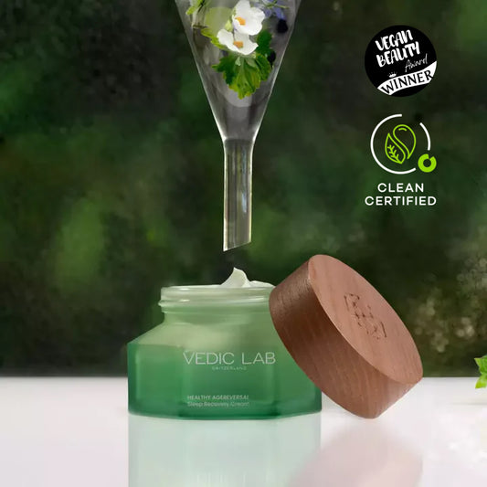 Vedic Lab sleep cream jar with flowers in funnel. Vegan Beauty Winner and Clean Certified logos. Green background.